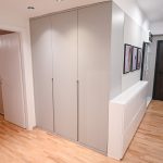 Large built-in grey wardrobe in an entrance hallway