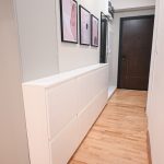 Long white shoe cabinet in a hallway